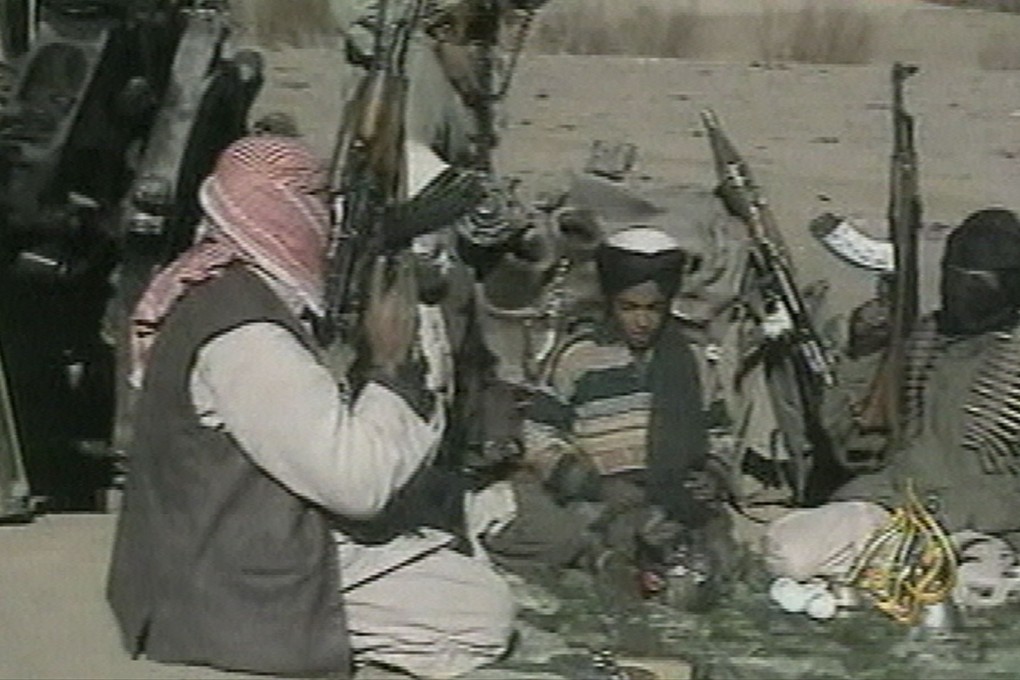 A young boy (centre) identified as Hamza bin Laden by Al-Jazeera television station in November, 2001. Photo: AP/Al-Jazeera