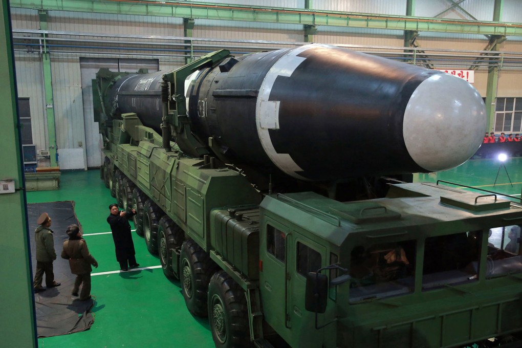 North Korean leader Kim Jong-un standing next to a Hwasong-15 long-range missile. Photo: AP