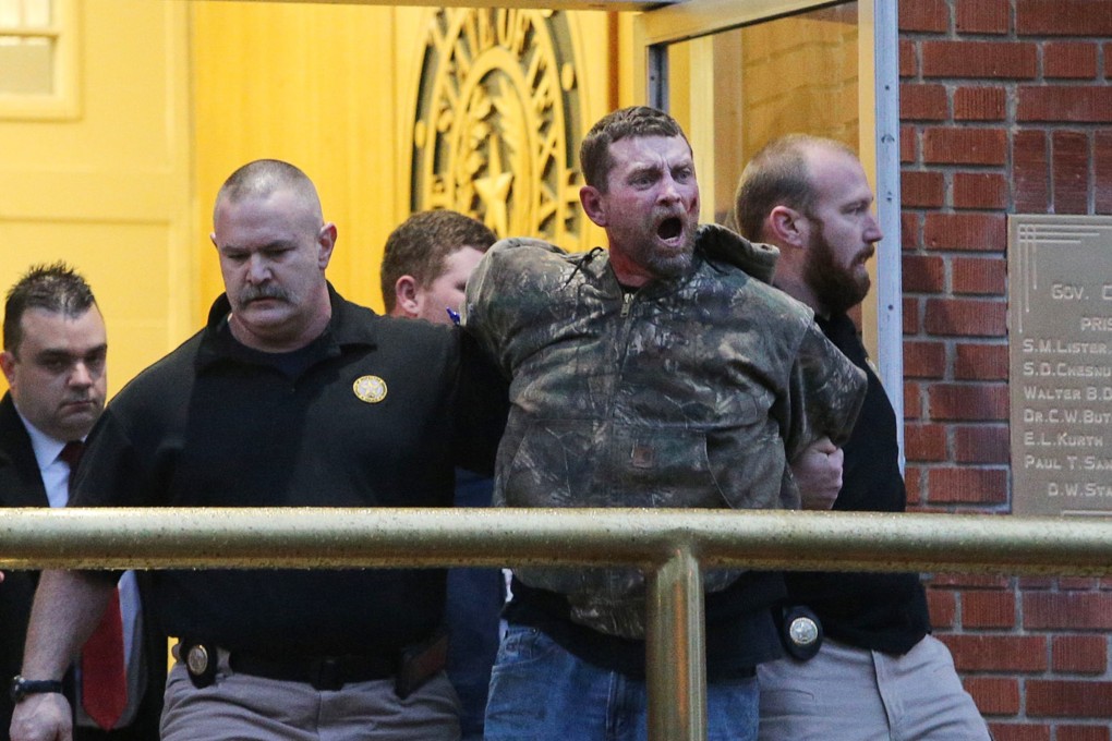 Gordon Coble, centre, is forcibly removed from the Texas State Penitentiary in Huntsville, Texas, after he started attacking other observers during the execution of his father, Billie Wayne Coble. Photo: AP