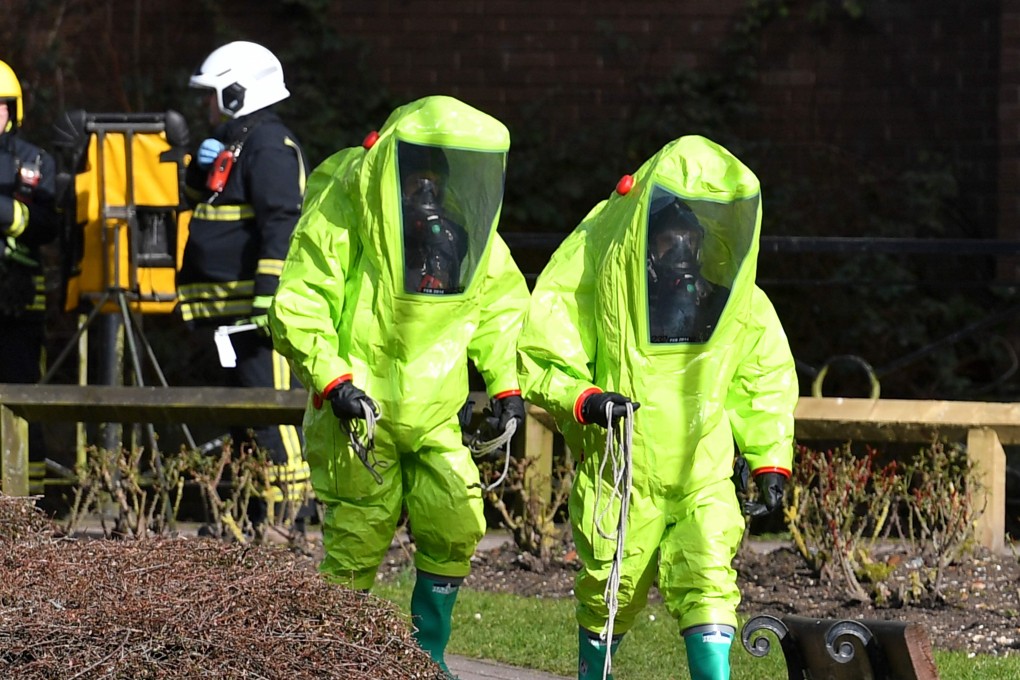 In this photo taken on March 08, 2018 members of the fire brigade in green biohazard encapsulated suits work to reattach the tent at the scene of a nerve agent attack at The Maltings shopping centre in Salisbury, southern England. Photo: AFP
