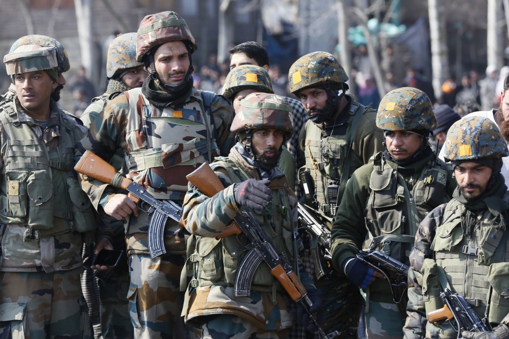 Indian army soldiers near the wreckage of an Indian helicopter. Photo: AP