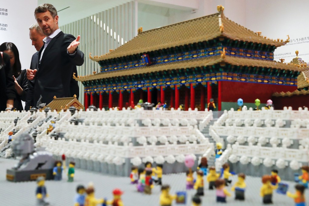In this file photo from September 23, 2017, Danish Crown Prince Frederik shows guests the Forbidden City made of Lego bricks at the Royal Modern Household Exhibition at the Danish Cultural Center, in Beijing. Photo: AP
