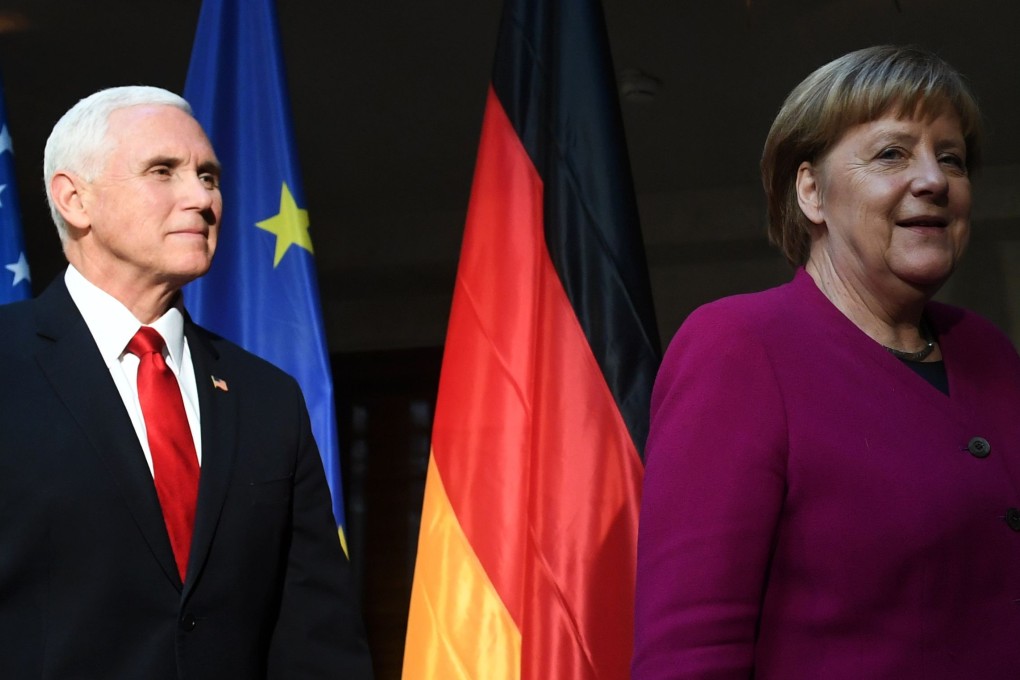 German Chancellor Angela Merkel (R) and US Vice-President Mike Pence (L) leave after a photo call during the 55th Munich Security Conference. Photo: AFP