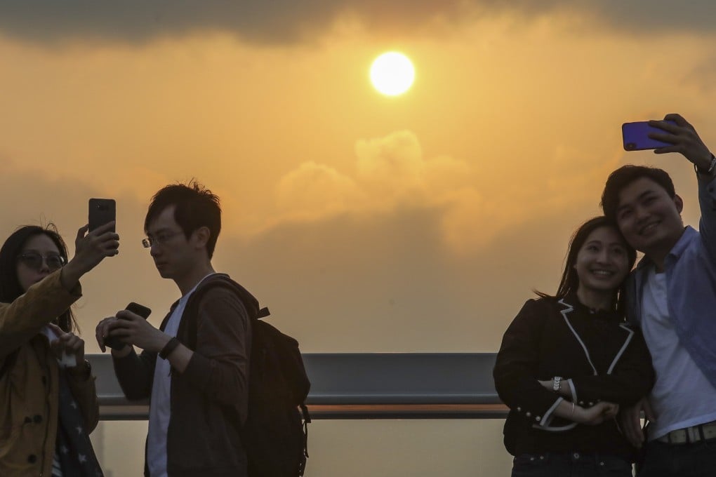 Sightseers in Tsim Sha Tsui on Saturday. Photo: Felix Wong