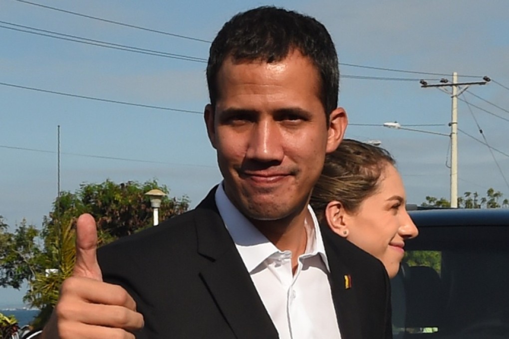 Venezuelan opposition leader and self-proclaimed acting president Juan Guaido gives the thumb up as he arrives for a meeting with Ecuadorean President Lenin Moreno in Salinas, Ecuador on March 2, 2019. Photo: AFP
