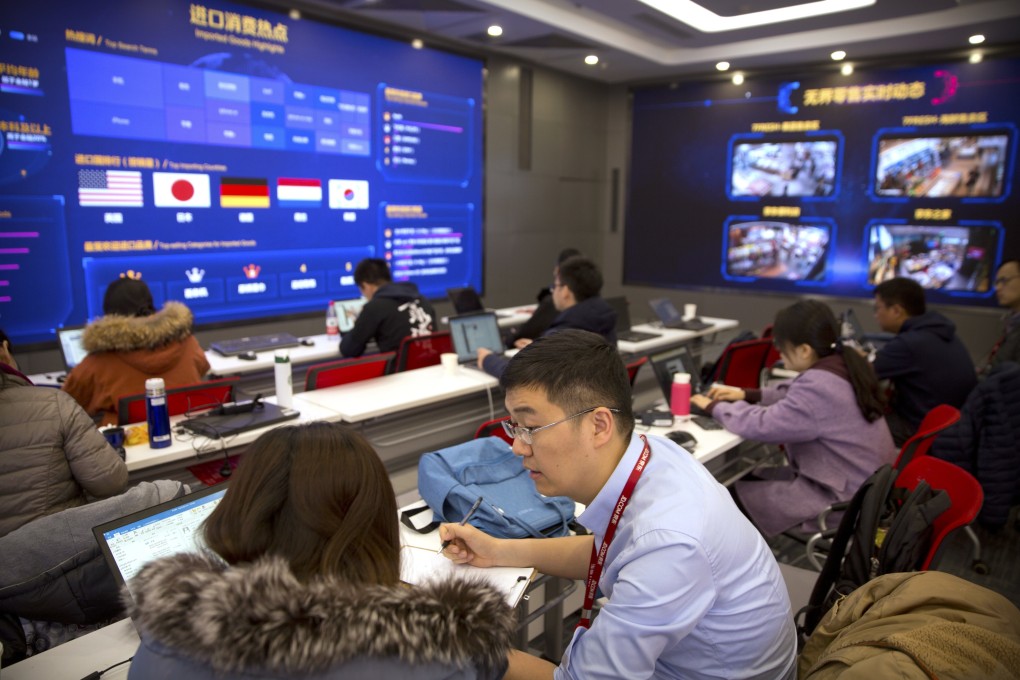 Workers talk as displays show sales data at the command centre at the headquarters of e-commerce retailer JD.com in Beijing on November 11, 2018. Photo: AP