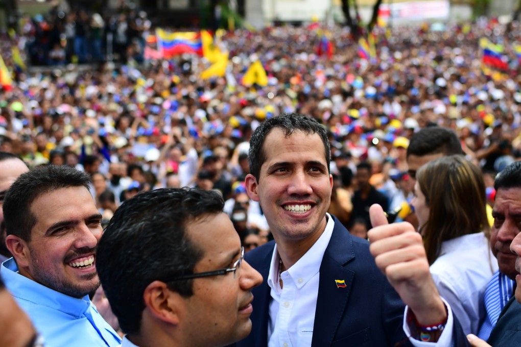 Venezuelan opposition leader and self-proclaimed acting president Juan Guaido gives the thumb’s up during a rally upon his arrival in Caracas on Monday. Photo: AFP