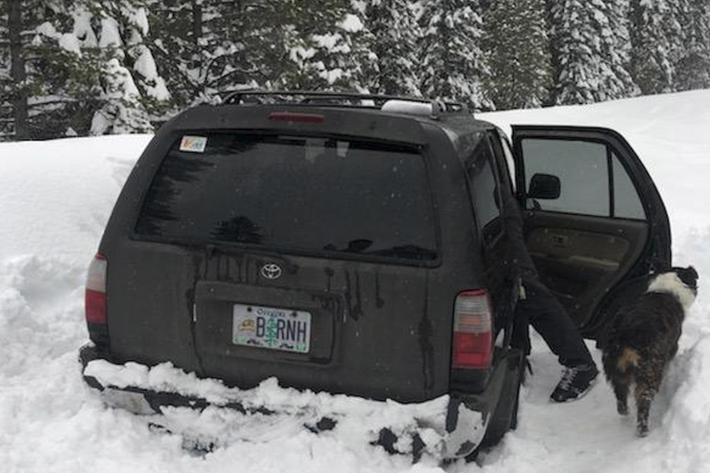 This photo released on Saturday shows Jeremy Taylor’s car, and dog Ally, after they were rescued in central Oregon. Photo: AP