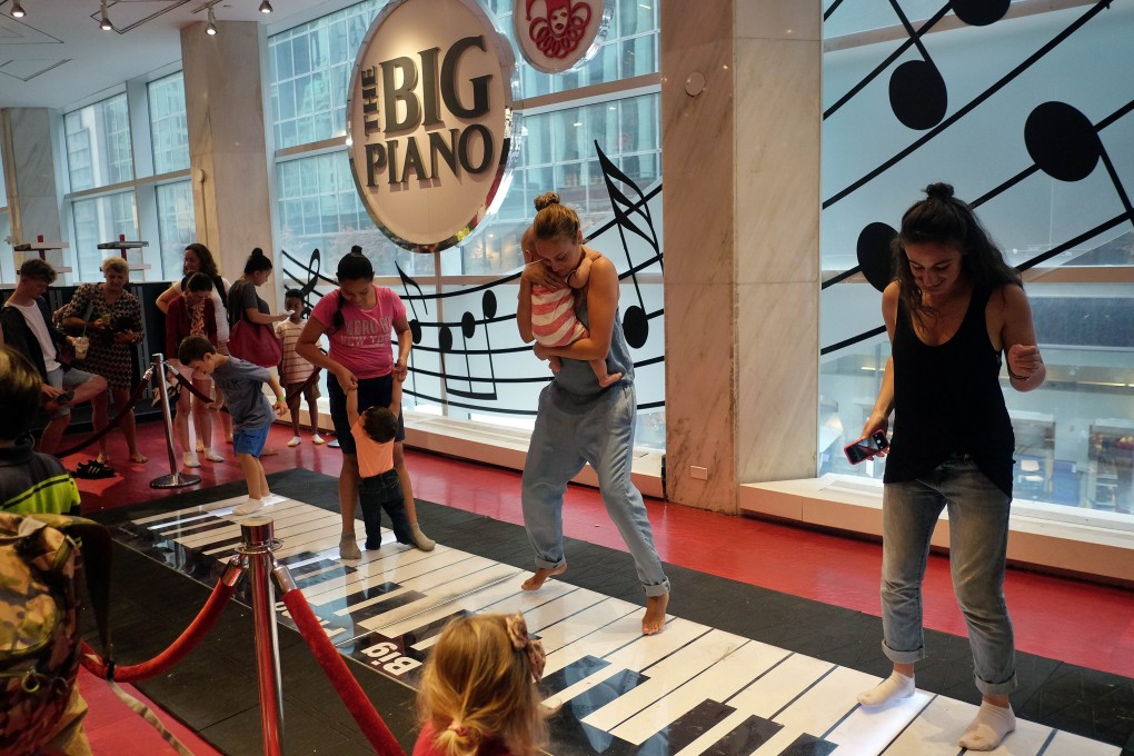 Customers experiencing the dance-on floor piano at the New York outlet of FAO Schwarz on its last day of operation on July 15, 2015. Former owner Toys’R’Us decided to close the Fifth Avenue store two months earlier, citing high and rising costs of running the 45,000-square-foot retail space. Photo: AFP