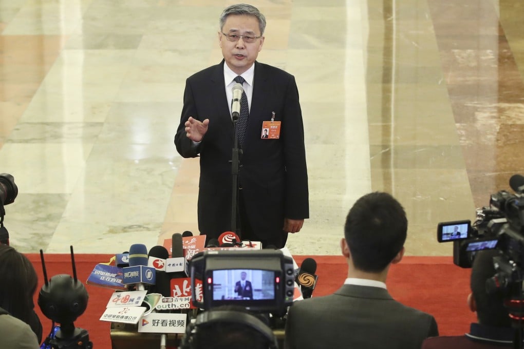 Guo Shuqing addresses the media. Photo: Xinhua