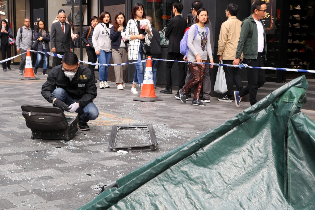 A police officer at the scene of a fallen window that killed a mainland Chinese woman in Tsim Sha Tsui. Picture: Edmond So