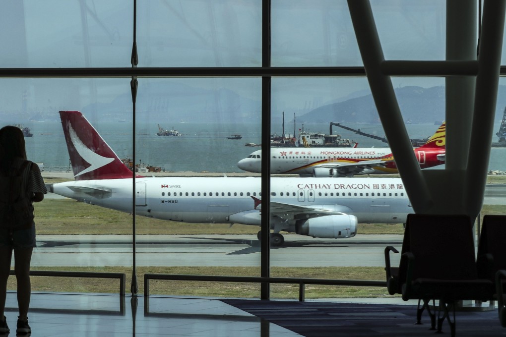 A Cathay Dragon plane and a Hong Kong Airlines plane (back right) at Hong Kong International Airport. Cathay Pacific, the parent company of Cathay Dragon, will begin contract talks with cabin crew on March 18. Photo: Roy Issa