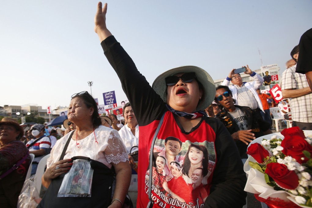 A supporter of Pheu Thai Party wearing a T-shirt of former prime ministers Thaksin Shinawatra and Yingluck Shinawatra. Photo: AP
