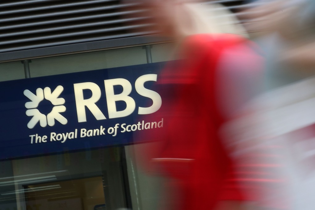 Pedestrians pass a branch of Royal Bank of Scotland. Photo: AFP