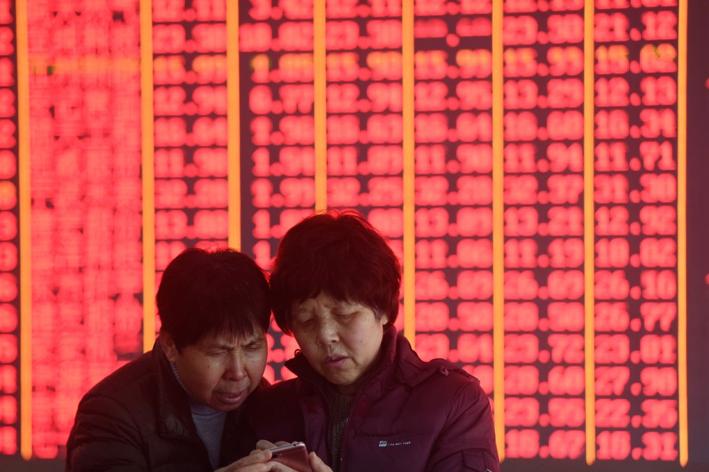 China stocks entered a bull market last week. Here, investors look at share prices in Hangzhou on March 4, 2019. In China, red signals gains. Photo: Xinhua