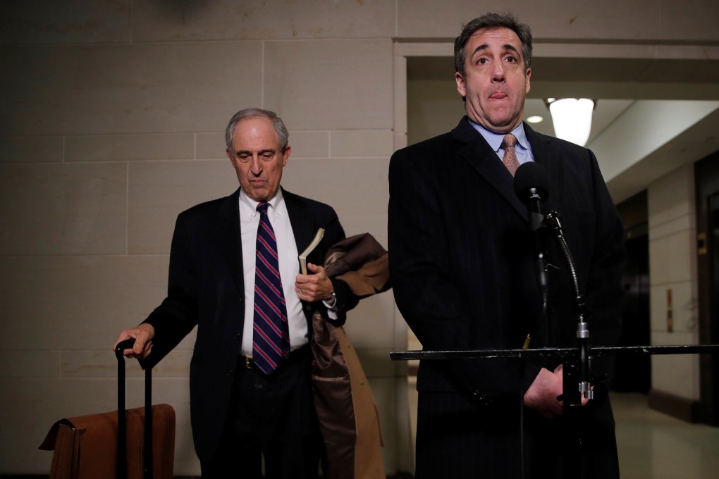 Michael Cohen (right), the former personal lawyer of US President Donald Trump, pauses while speaking to reporters, accompanied by his own lawyer and adviser Lanny Davis, after testifying before a closed House Intelligence Committee hearing on Capitol Hill in Washington on Wednesday. Photo: Reuters