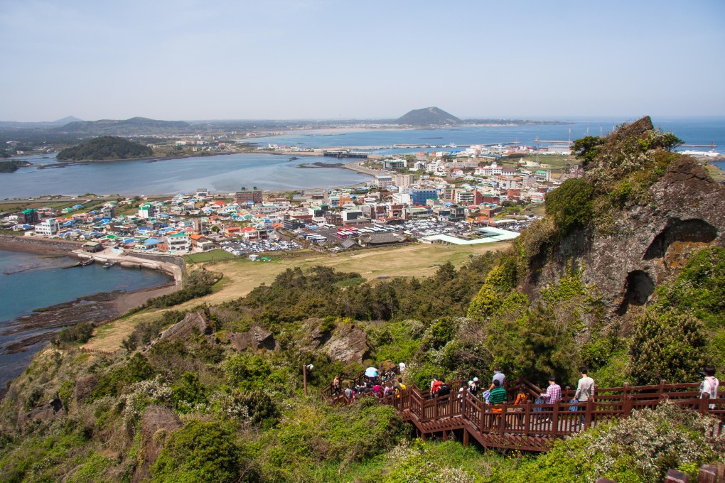 People walking on the volcanic island of Jeju, which is dominated by Mount Hallasan, a volcano and the highest mountain in South Korea. Photo: Alamy
