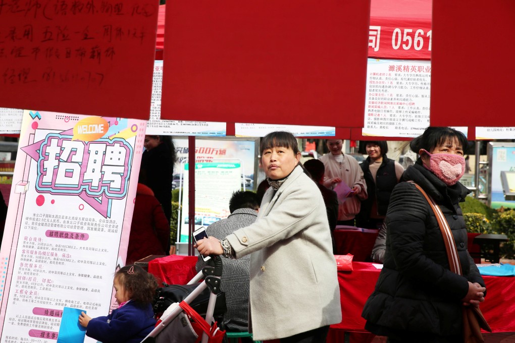 Job seekers look at the job advertisements at a job fair for women on the International Women's Day in Huaibei, Anhui province, on Friday. Photo: Reuters