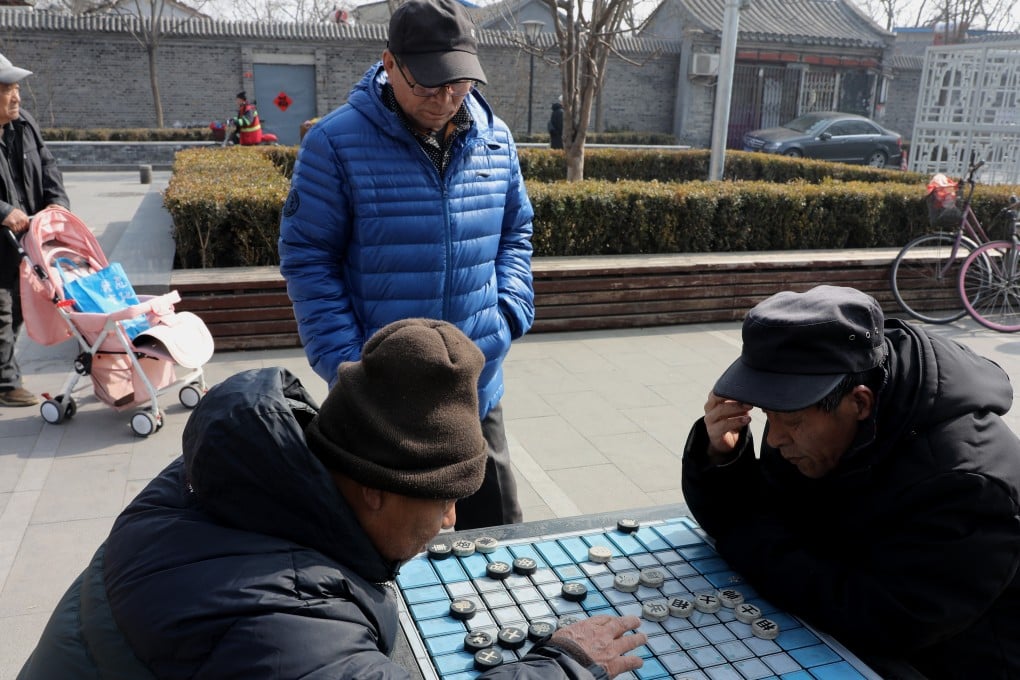 Two men play Chinese chess in a hutong at Bell Tower square in Beijing on February 27, 2019. Photo: Simon Song