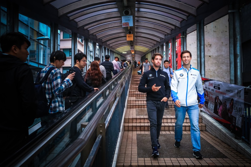 Antonio Felix da Costa and Alexander Sims walk alongside the Central escalator. Photos: BMW