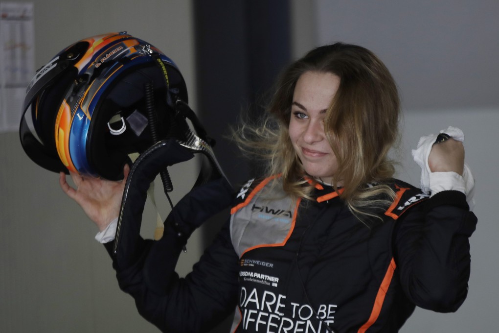 Sophia Floersch smiles in the garage after driving her Van Amersfoort Racing team test car at the Monza racetrack, northern Italy. Photo: AP