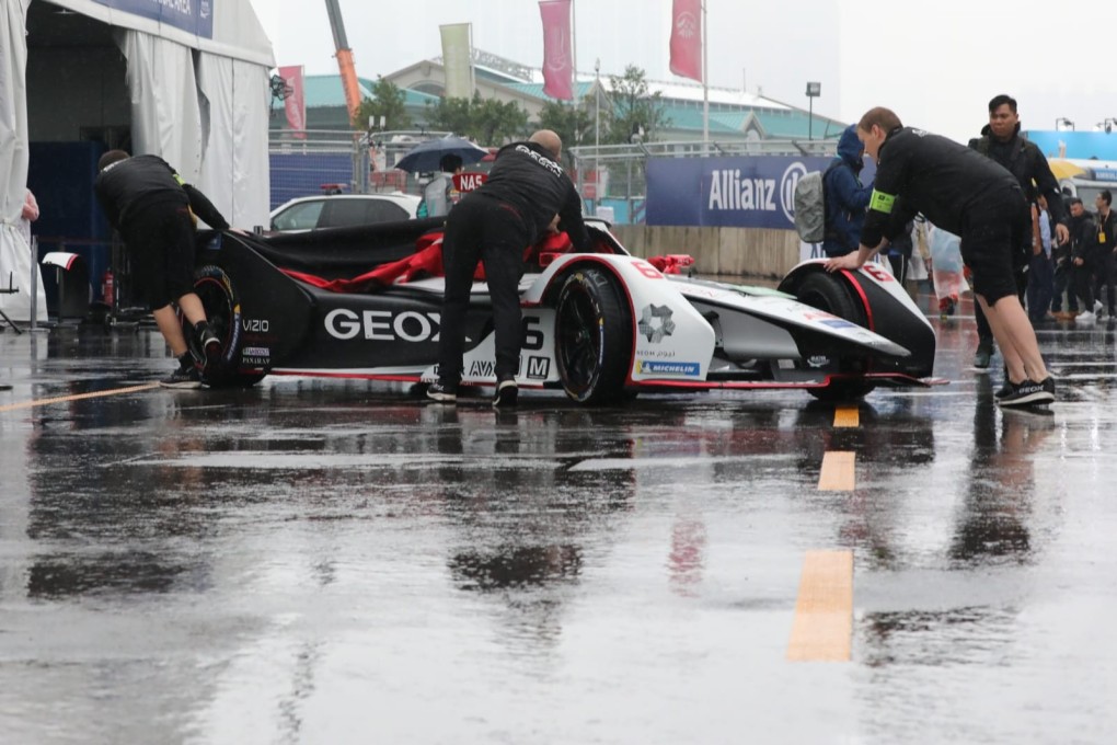 The GEOX Dragon team push the car through a wet pit lane at the Hong Kong E-Prix. Photo: Felix Wong