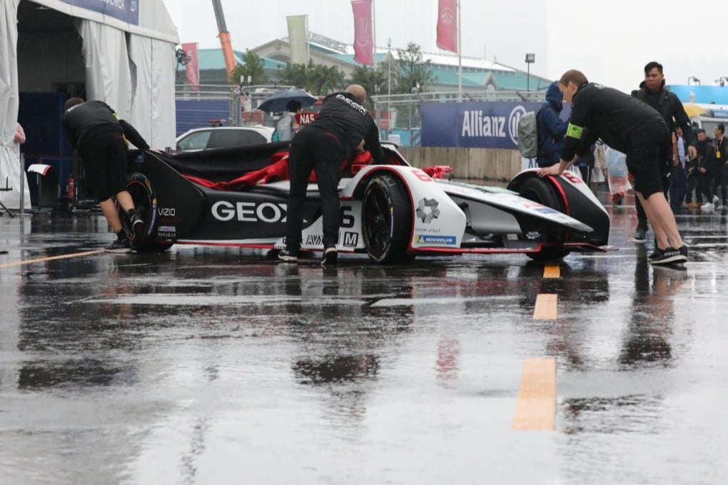 The GEOX Dragon team push the car through a wet pit lane at the Hong Kong E-Prix. Photo: Felix Wong