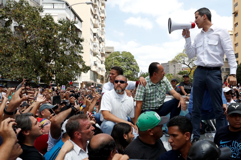 Venezuelan opposition leader Juan Guaido, who many nations have recognised as the country's rightful interim ruler, speaking at a rally against Venezuelan President Nicolas Maduro's government in Caracas on Saturday. Photo: Reuters