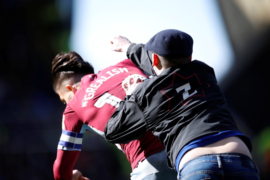 Aston Villa's Jack Grealish is attacked by the Birmingham fan. Photo: Reuters
