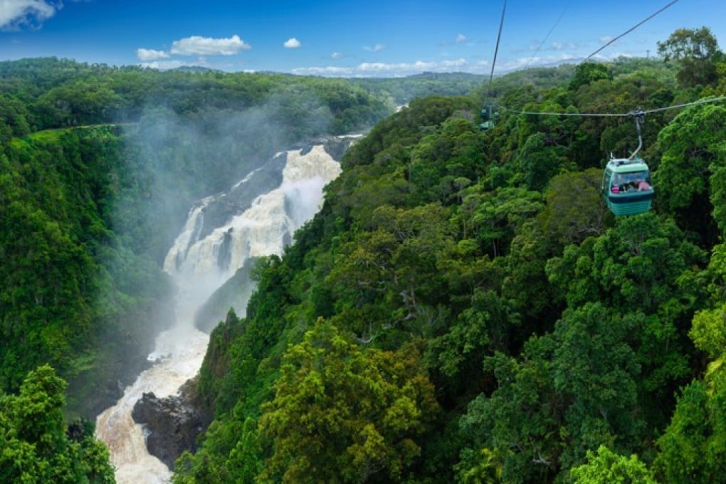 Cairns’ Skyrail Rainforest Cableway soars above Barron Falls, in Queensland, Australia.