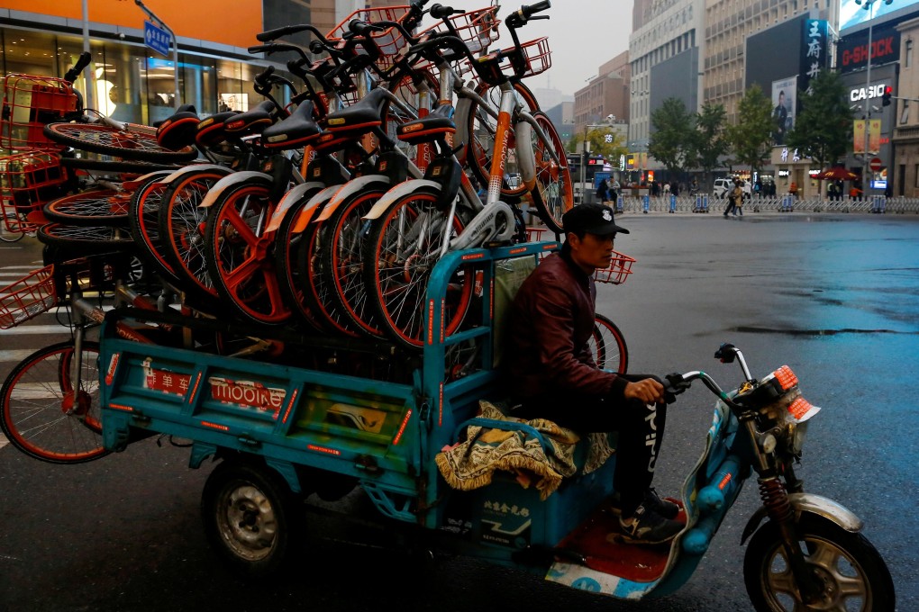 A man rides a tricycle transporting Mobike shared bikes near Wangfujing Street in Beijing on October 15, 2018. Photo: Reuters