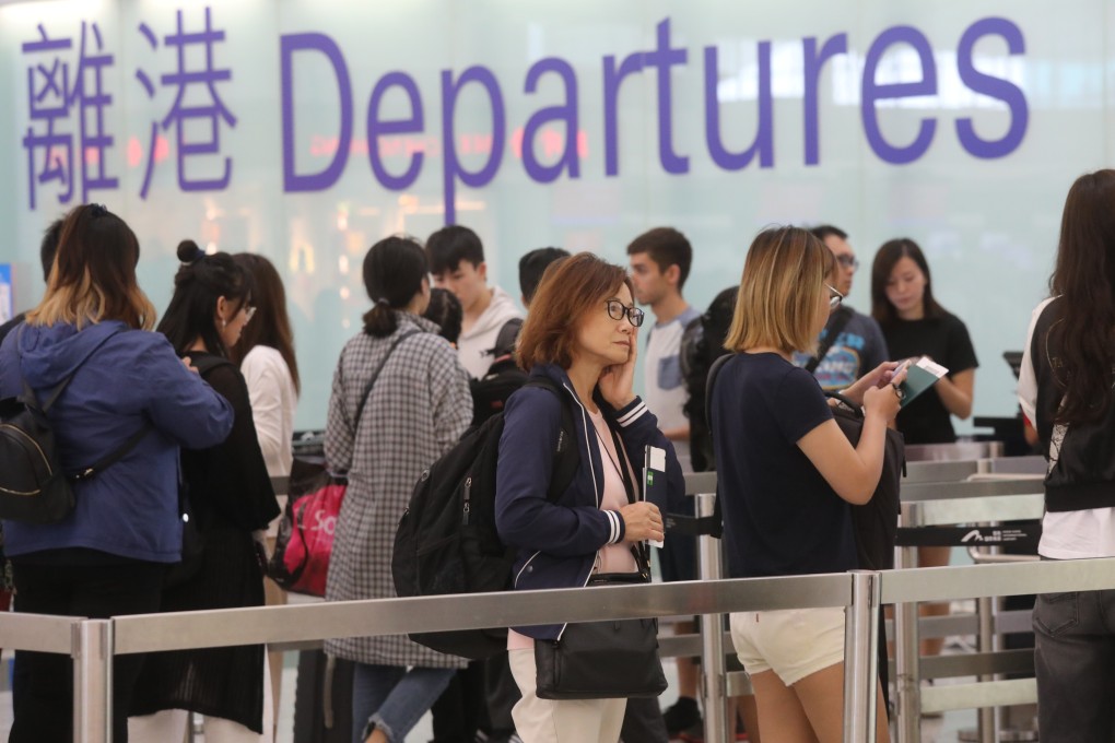 Passengers queue up at the departure hall for the immigration check at the Hong Kong airport on 17 September 2018. Photo: SCMP/K. Y. Cheng