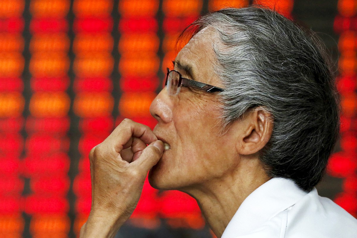 A stock investor checks prices in a brokerage house in Fuyang in central China's Anhui province. Photo: Reuters