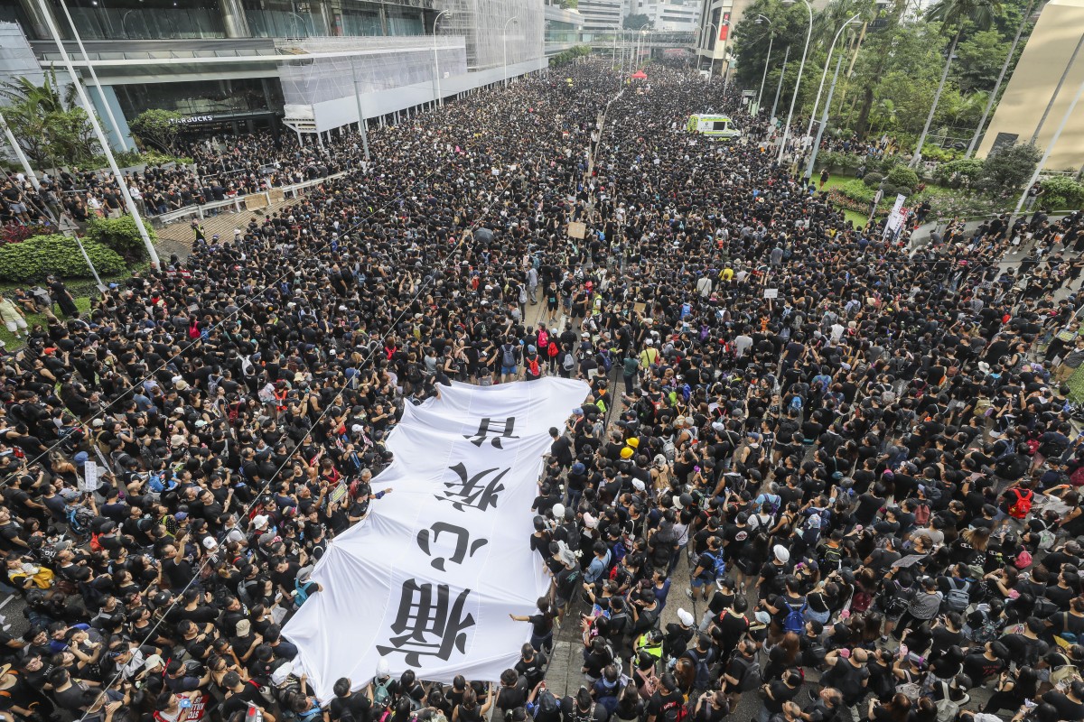 Protesters march outside Pacific Place in Admiralty to the Central Government Offices in Hong Kong on Sunday. Photo: Dickson Lee