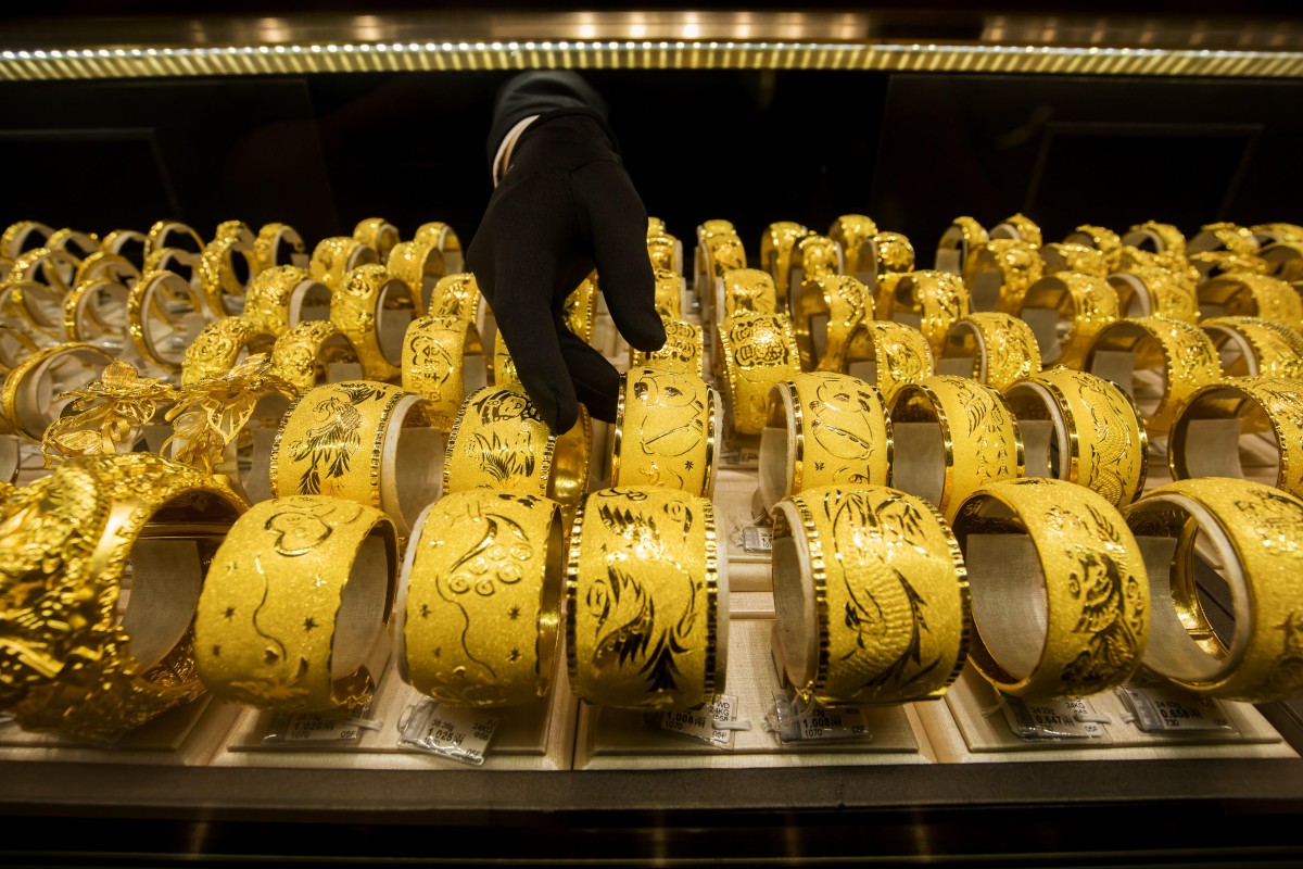 An employee arranges gold bands at Chow Tai Fook Jewellery in Hong Kong. Photo: Bloomberg 