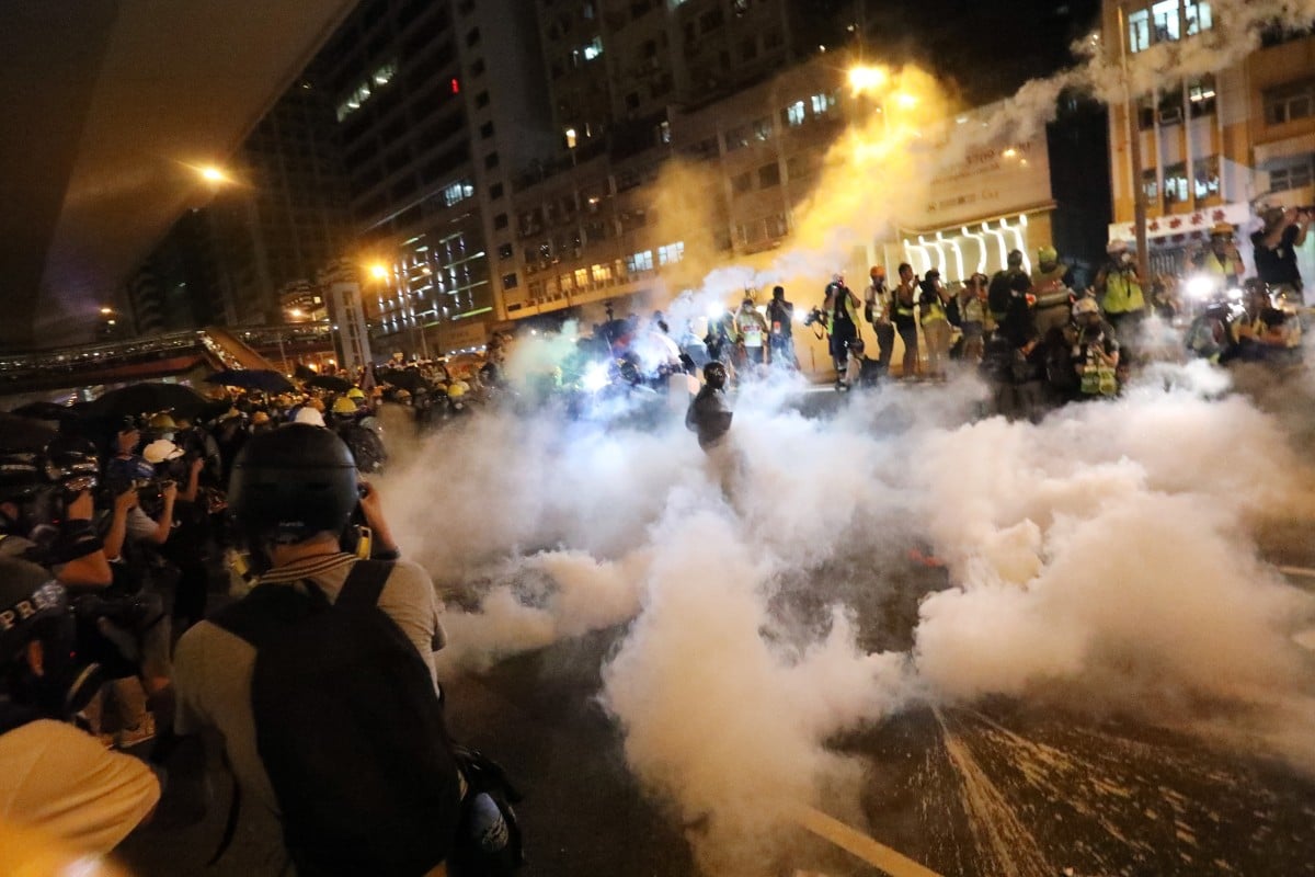 Skirmishes break out as riot police use tear gas on protesters. Photo: Felix Wong