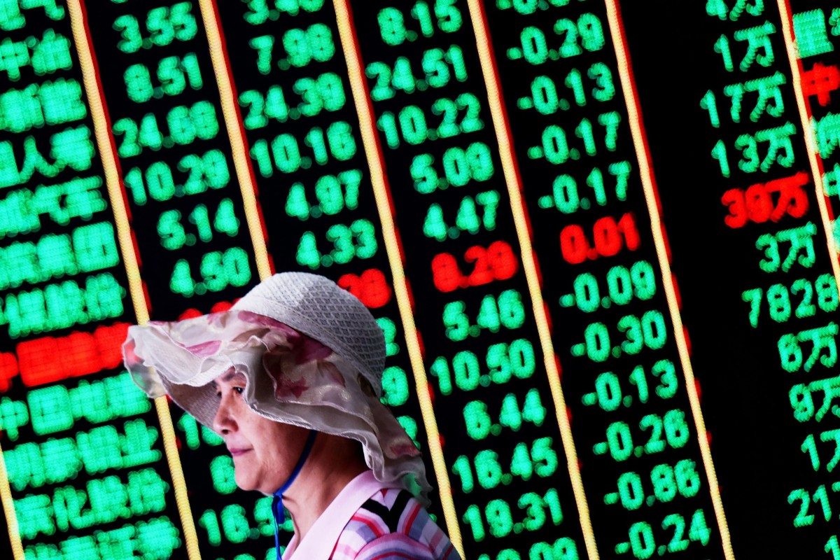 An investor walks past a screen showing stock market figures at a securities company in Hangzhou in China's Zhejiang province on June 19, 2018. Photo: Agence France-Presse