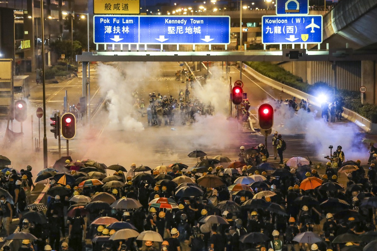 Police fire teargas at anti-extradition bill protesters as they march towards the Liaison Office of the Central People's Government in Sai Ying Pun on Sunday. Photo: Sam Tsang