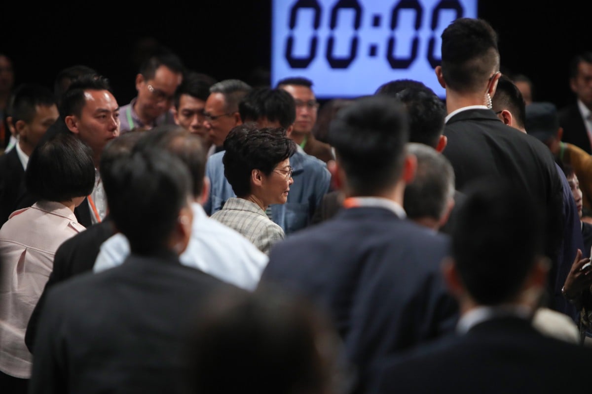 Hong Kong Chief Executive Carrie Lam makes her way out of Queen Elizabeth Stadium, but did not leave the venue for another four hours. Photo: Winson Wong
