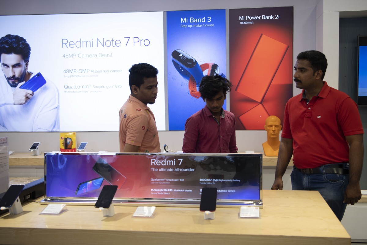 Xiaomi shares soar after founder says it will launch 10 5G models. Above, customers at a Xiaomi store in Chennai, India. Photo: Xinhua