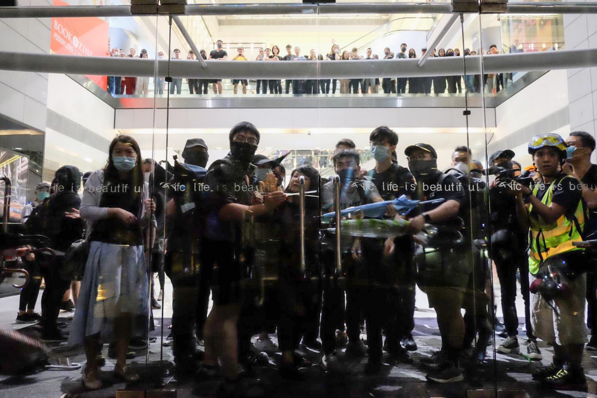 Protesters barricade themselves inside IFC mall. Photo: Stanley Shin