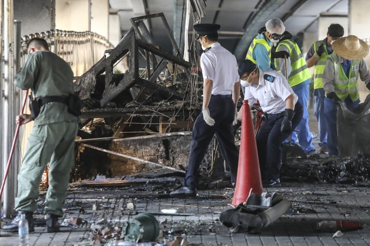 Cleanup is under way in Hong Kong. Here workers clear protest-related debris from a footbridge at the Cross-Harbour Tunnel. Photo: K.Y. Cheng
