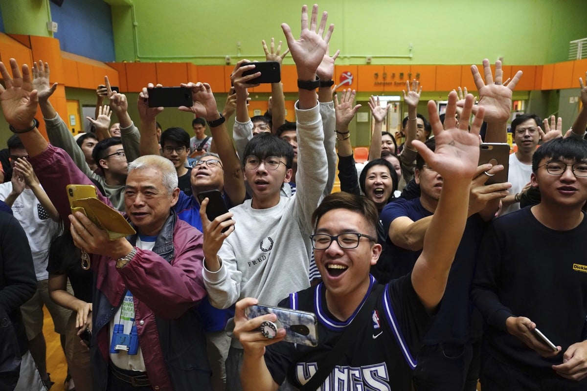 Supporters of pro-democracy candidate Angus Wong celebrate his victory. Photo: AP