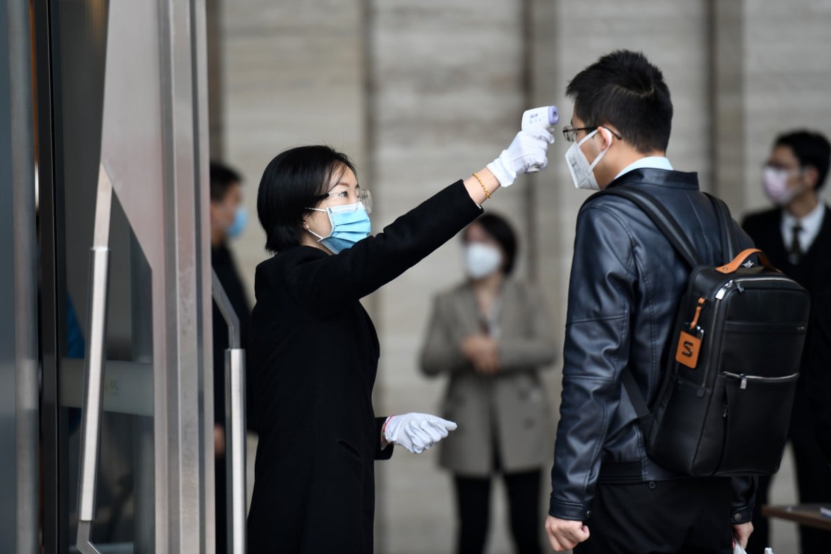 A man's temperature is taken as he enters Ping An International Financial Center in Shenzhen, south China's Guangdong province, on February 10, 2020. Photo: Xinhua

