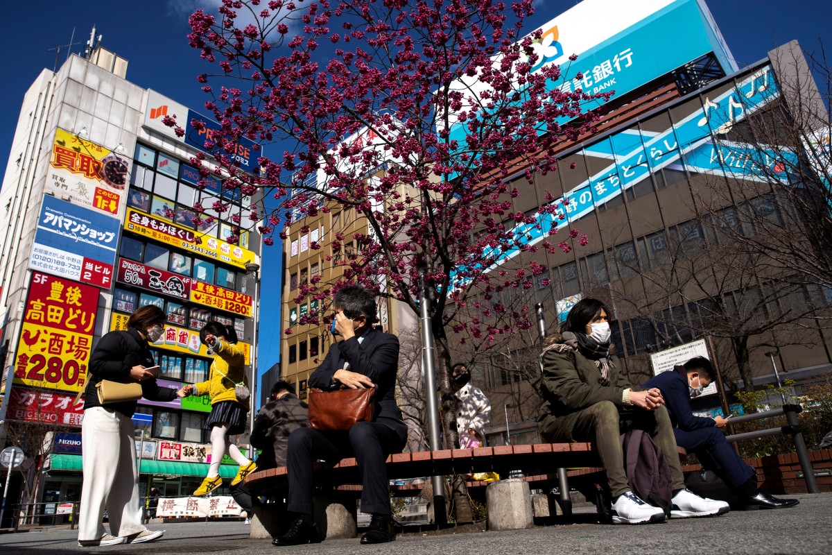 People wearing face masks are seen in front of Nakano station in Tokyo as Japan wrestles with the outbreak of coronavirus. Photo: Reuters 