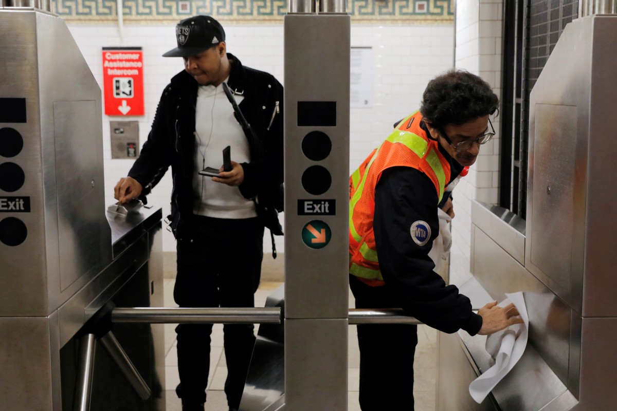 A worker wipes down a turnstile at the Broad Street subway station in New York after more cases of coronavirus were confirmed in the Big Apple. Photo: Reuters