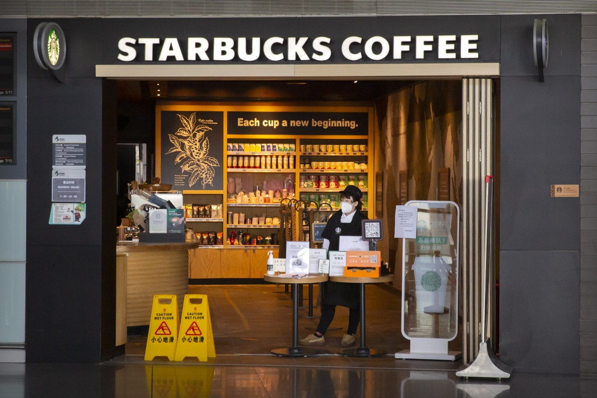 A Starbucks employee waits for customers at a shop at Beijing Capital International Airport in Beijing on  March 28, 2020. Photo: Associated Press 
