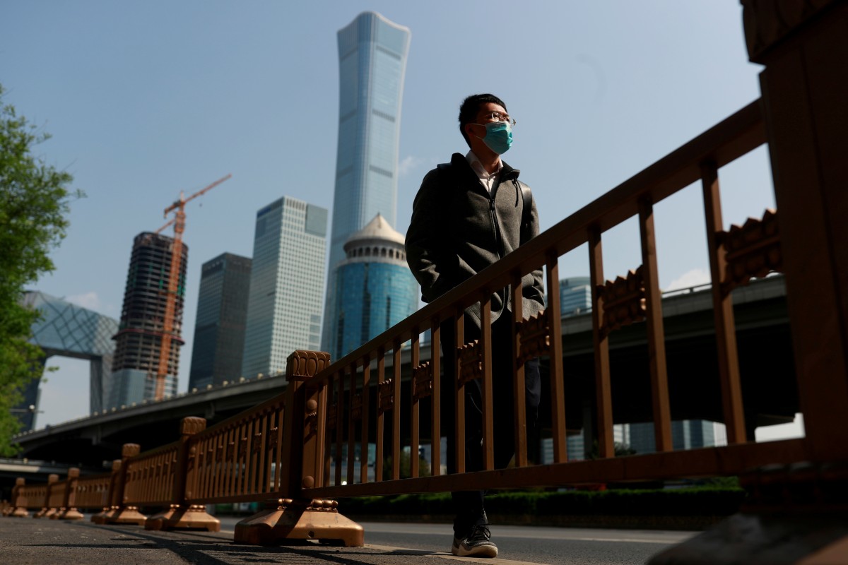 A man walks in Beijing’s Central Business District during morning rush hour as the country recovers from the coronavirus disease on April 17, 2020. Photo: Reuters
