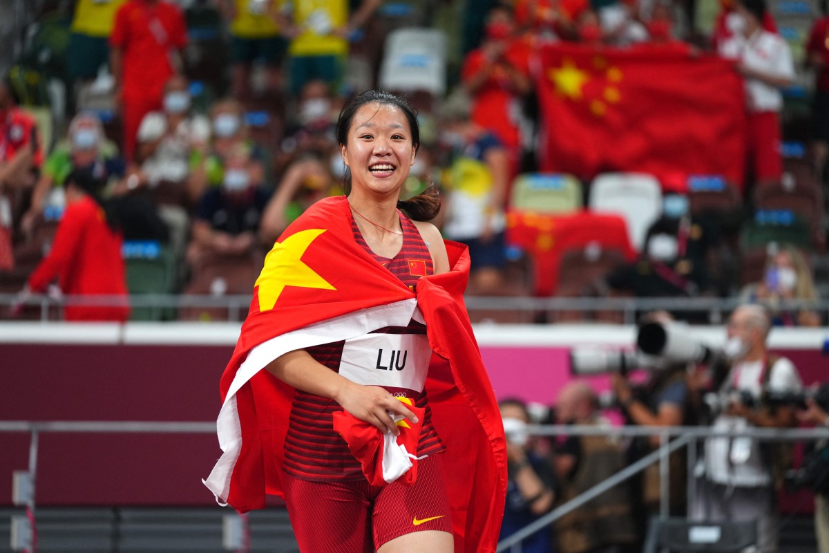 China’s Liu Shiying celebrates with her national flag after winning the gold medal in the women’s javelin final at the Tokyo 2020 Olympics. Photo: AFP