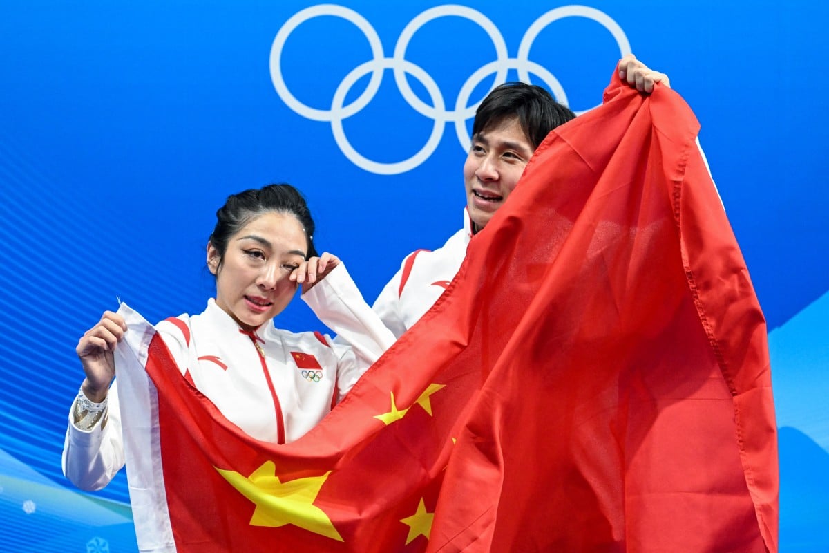 China’s Sui Wenjing (left) and Han Cong celebrate winning the gold medal in the pairs figure skating. Photo: AFP